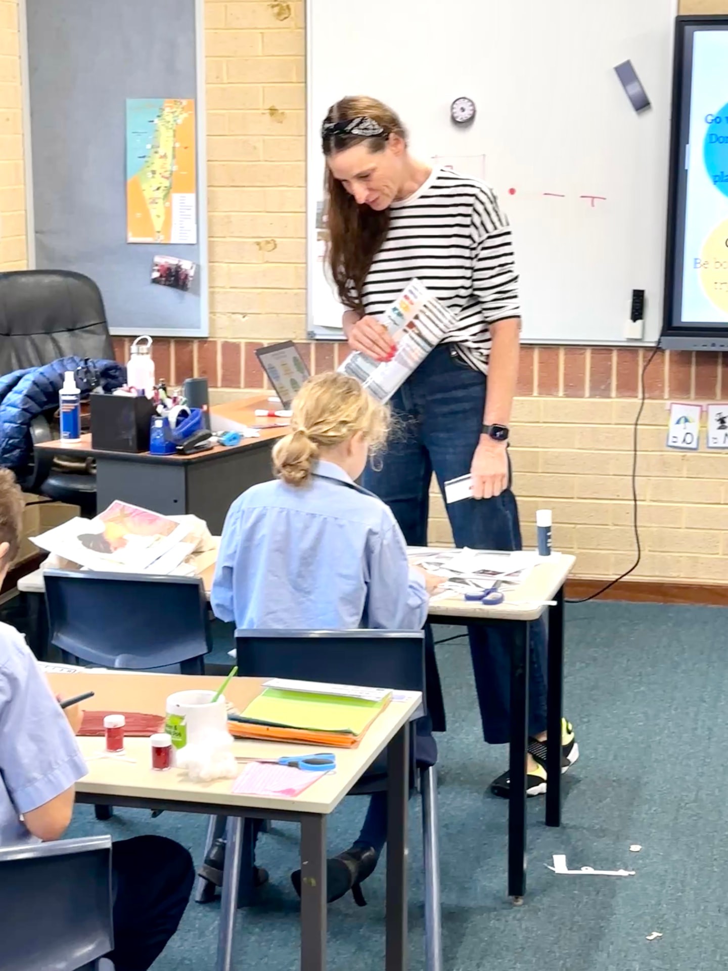 A classroom fashion workshop with an instructor and young designers